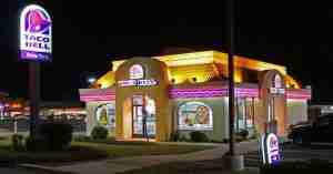 Is Taco Bell gluten-free? An image of Taco Bell fast food building set in the dark