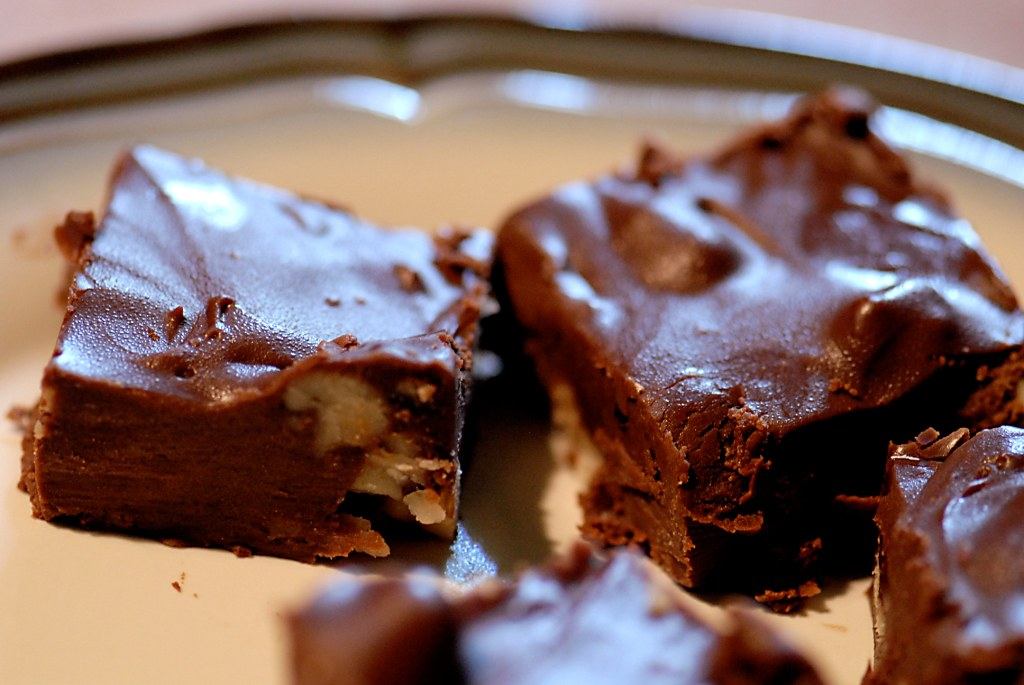 A close up image of chocolate fudge with nuts