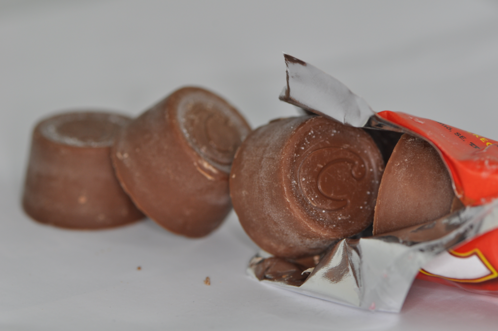 An image of opened Rolo Chocolate pack with rolo pieces