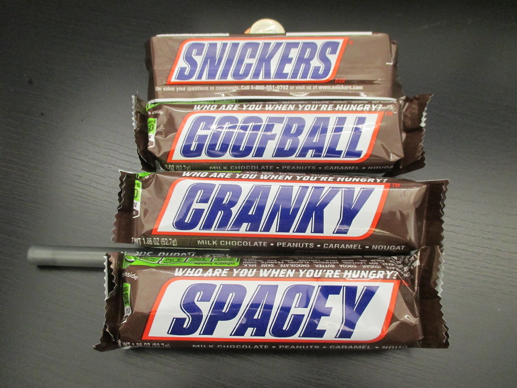 A collection of Snickers Chocolate Bars with different texts on its packaging
