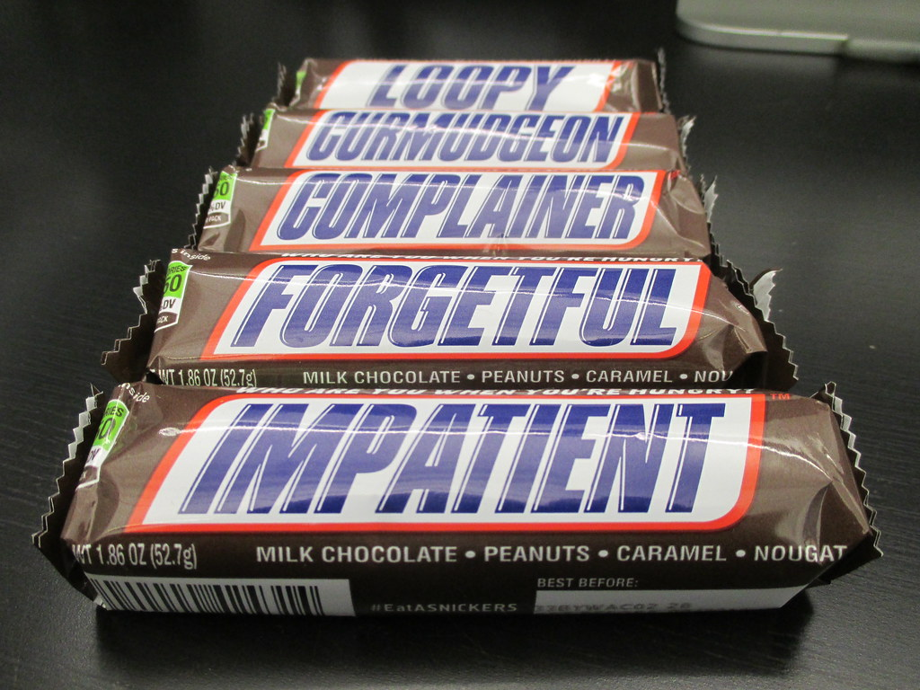 An image of Snickers chocolate bars with different texts on their packaging