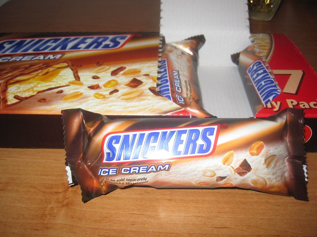 An image of unopened Snickers ice cream bar and a pack of it at the back