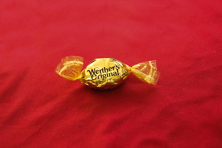 An image of wrapped Werther's Original Candy on a red background