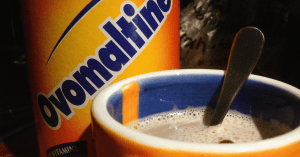 Is Ovaltine gluten-free? An image of Ovaltine in a can and a glass of hot chocolate
